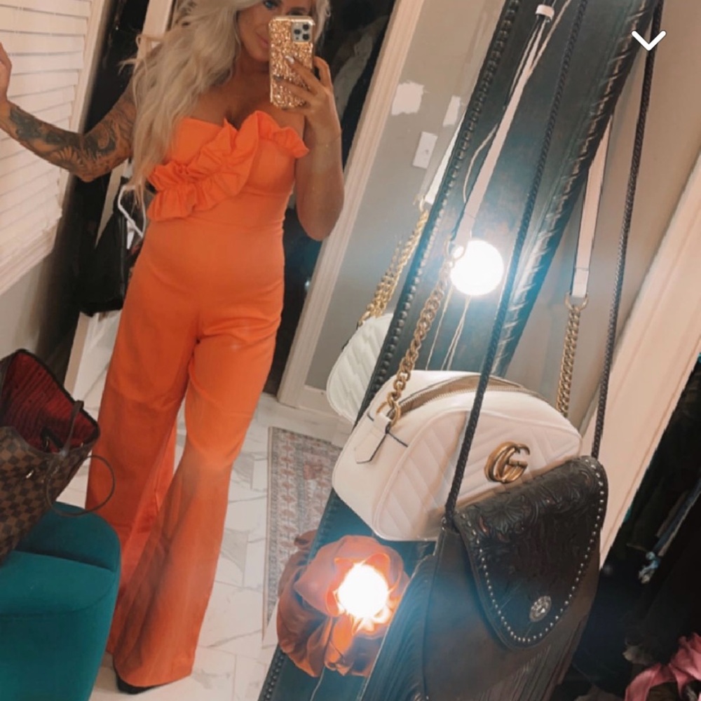 This stunning orange romper comes with the tags still attached!